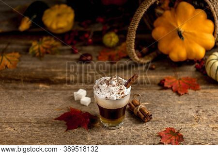 Pumpkin Latte With Cinamon Powder And Delicious Flavours On The Old Textured Wood Table With Colorfu