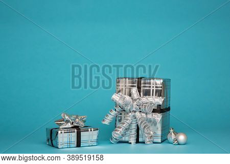 Christmas gifts wrapped in ribbed silver paper for Christmas celebrations