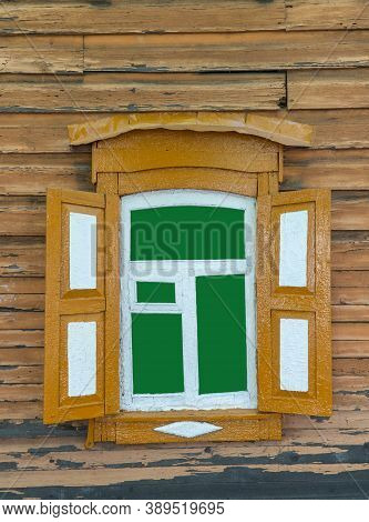 Old Wooden Window With Open Shutters On The Wall With Worn Paint. Ancient, Wooden Architecture.