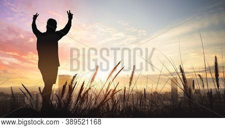 Silhouette Of Man On The Big City With Sunset Sky Background