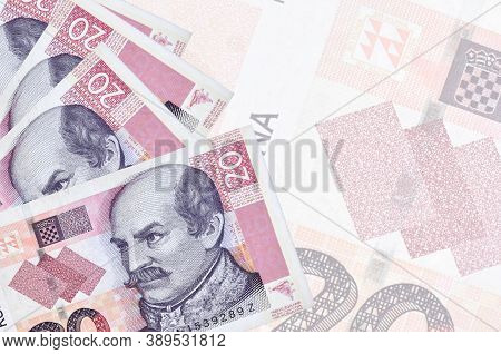 20 Croatian Kuna Bills Lies In Stack On Background Of Big Semi-transparent Banknote. Abstract Busine