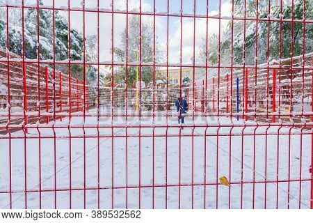 The Basketball Court, Closed By A Red Fence, Is Covered With Snow.
