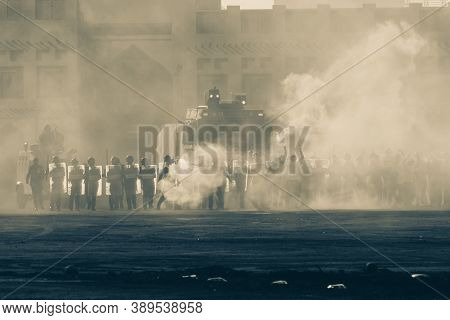 Military Police Riot Response To A Protest With Tear Gas, Smoke, Fire, Explosions. Political Express