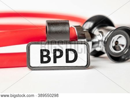 Bpd: Borderline Personality Disorder Lettering On A Business Card With A Holder, Next To The Red Ste