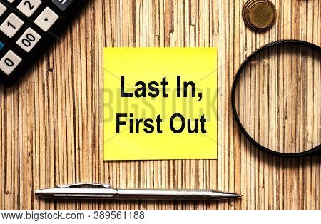 Text Last In, First Uot In Yellow Notes With Pen