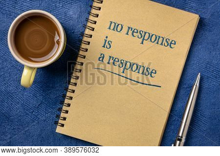 no response is a response note in a spiral notebook with a cup of coffee - answer, reply and communication concept