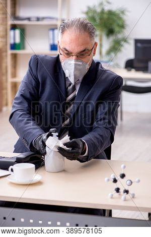 Old male boss employee working during pandemic