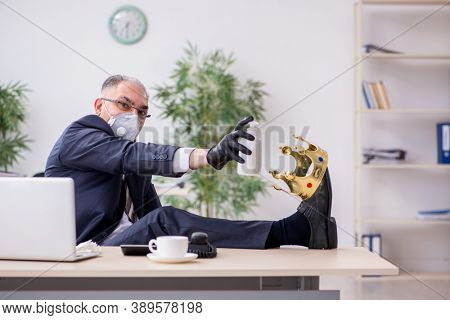 Old male boss employee working during pandemic