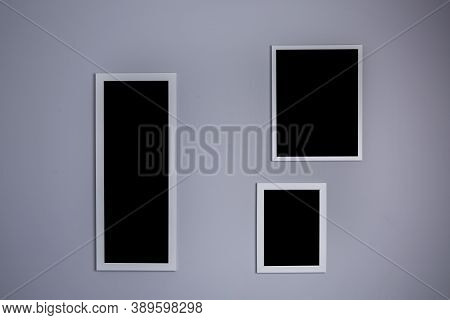 Poster Mockup With Three Frames On Empty Grey Wall