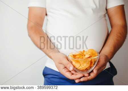 Unhealthy Eating, Fast Food, Mindless Snacking, Diet, Imbalanced Ration. Overweight Man Eating Salte