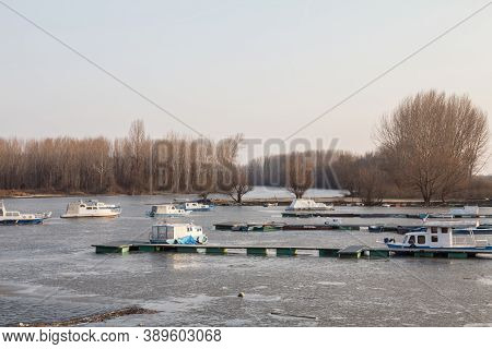 Panorama Of The Port Of Kovin, On The Danube, With Boats And Ship Anchored In Frozen Waters In Winte