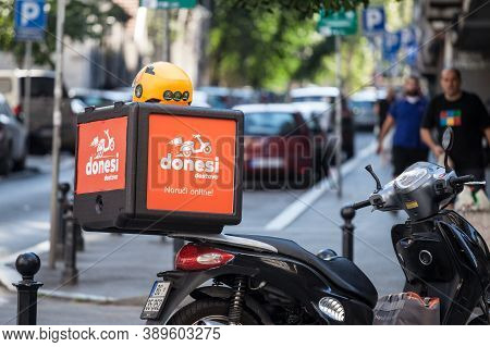 Belgrade, Serbia - August 22, 2020: Donesi Dostava Logo On A Scooter On A Delivery Guy In Belgrade. 
