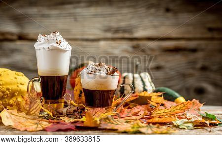 Pumpkin Latte With Cinamon Powder And Delicious Flavours On The Old Textured Wood Table With Colorfu