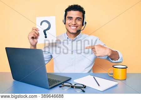 Young handsome hispanic man holding question mark as customer support pointing finger to one self smiling happy and proud 