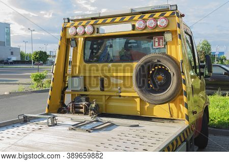 Warsaw, Poland - July 29, 2020: Yellow Car Tow Truck In The Parking Lot. Car Tow Truck For Small And