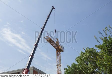 Dismantling And Assembling A Construction Crane. Dismantling A Tower Crane With Another Crane. Speci