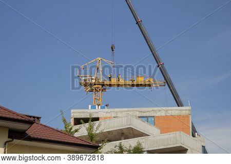 Dismantling And Assembling A Construction Crane. Dismantling A Tower Crane With Another Crane. Speci