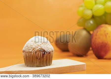 Fresh Muffin Sprinkled With Powdered Sugar. Background For Text. Fresh Fruit Muffin And Fruit