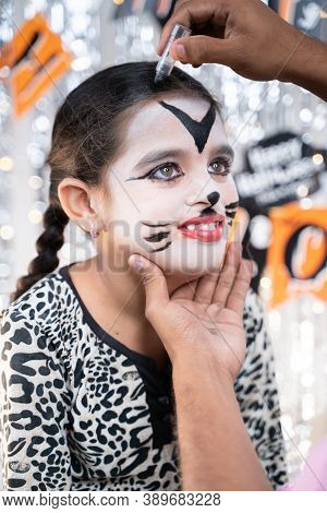 Parent Helping Her Daughter To Get Ready For Halloween By Doing Make-up - Concept Of Halloween, Holi
