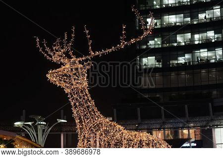 Christmas Installation - Deer On Night City Background. Christmas Deer Installation In Milan, Italy