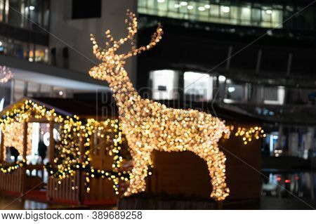 Blurred Lights Of Christmas Installation - Defocused Lights Of Deer On Night City Background. Christ