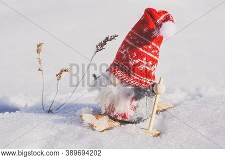 Santa Claus dolls on a white carpet as Christmas decorations