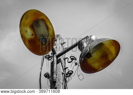Old Electric Rusty Metal Street Lamp On Concrete Lamppost - Black And White Image With Selected Colo