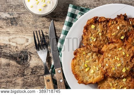 Traditional Jewish Latkes Or Potato Pancakes On Wooden Table. Top View. Copy Space