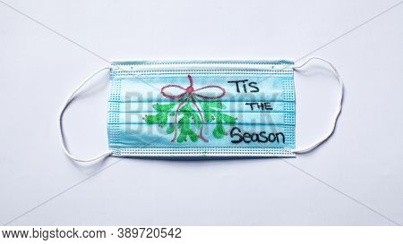 A Medical Mask With A Mistletoe And 