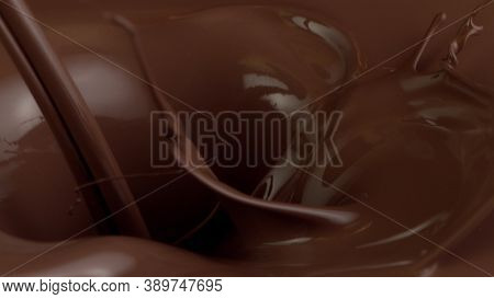 Detail of pouring hot chcocolate with splash. Studio macro shot.