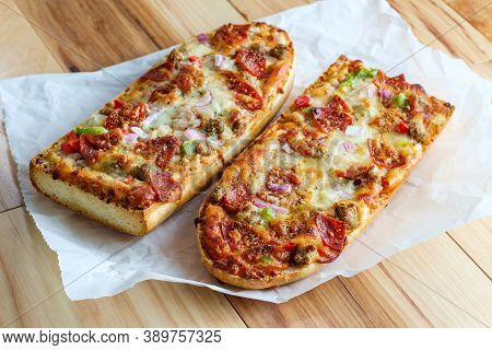 Supreme French Bread Pizza With Pepperoni Sausage Black Olives Red Onion And Green Bell Pepper Toppi