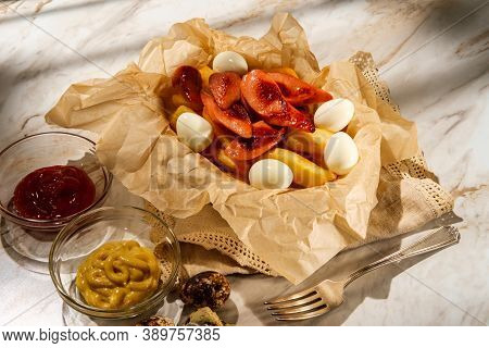 Peruvian Fast-food Salchipapas French Fries And Sliced Sausage With Hard-boiled Quail Eggs