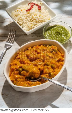 Authentic Indian Vegetable Korma Curry Dinner With Green Chutney And Basmati Rice