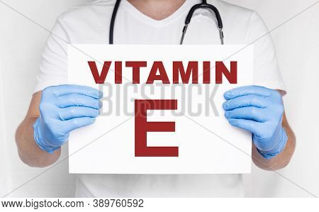 The Male Doctor Holding A Card With Vitamin E Text, Medical Concept. Treatment And Prevention With V