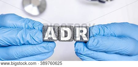 Adr Adverse Drug Reaction - Word From Stone Blocks With Letters Holding By A Doctor's Hands In Medic