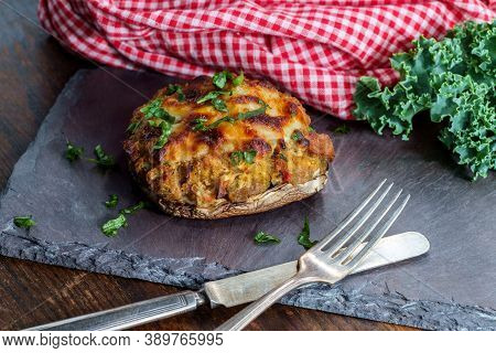 Stuffed Seasoned Large Portobello Mushroom On Rustic Slate Slab With Dark Moody Lighting