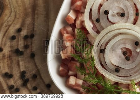Italian Pancetta, Bacon Cubes, Diced Ham, Cutted Pork, Sliced Onion, Pepper In Square White Plate On