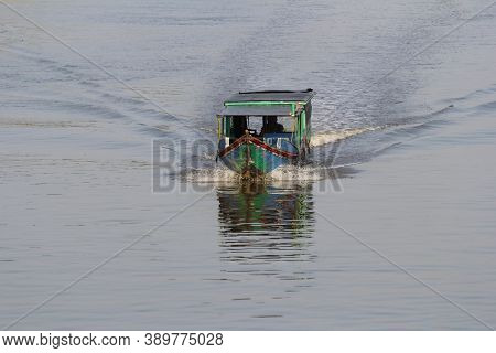 Lampung, Indonesia. September 15, 2013: A Traditional Motorboat Speeds Up The Mesuji River In Lampun