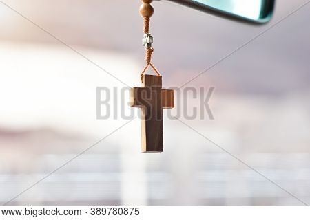 Christian Cross Hangs On The Mirror In The Car. Concept Of Religiosity And Faith In God.