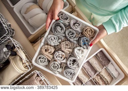 Unidentified Neat Housewife Puts Container With Socks, Panties And Underwear. Clothes Storage.