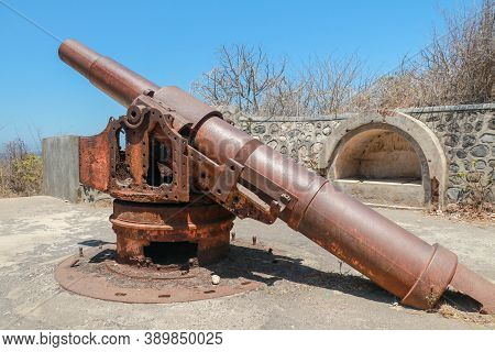 Old Rusted Cannon From World War Ii. Japanese Cannon Meriam Jepang In A Stone Fortification On The I