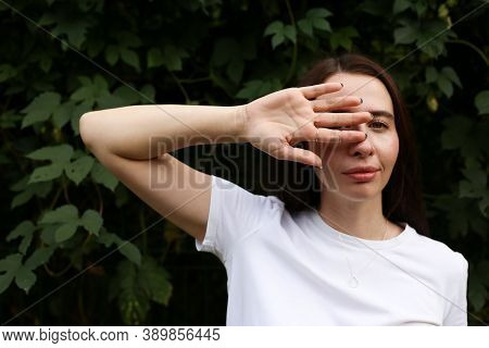 Portrait Of A Woman Covering Her Eyes With Her Hand