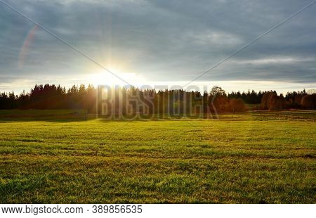 Beautiful Sunset Over Meadow And Forest Near Kvilda Village In Sumava National Park Landscape.