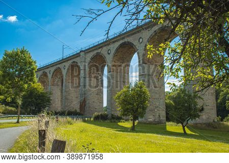 Train Viaduct In Altenbeken,  North Rhine Westphalia, Germany. Old Stone Railway Surrounded By Green