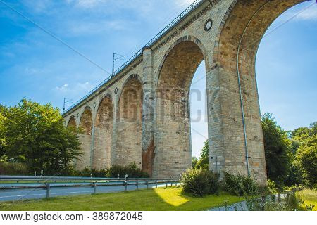 Train Viaduct In Altenbeken,  North Rhine Westphalia, Germany. Old Stone Railway Surrounded By Green