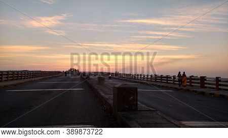 Highway Bridge With Sunset And Pedestrians Walking