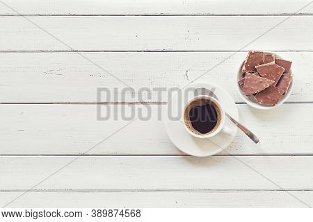 Cup Of Coffee With Chocolate On Wooden Table Top View