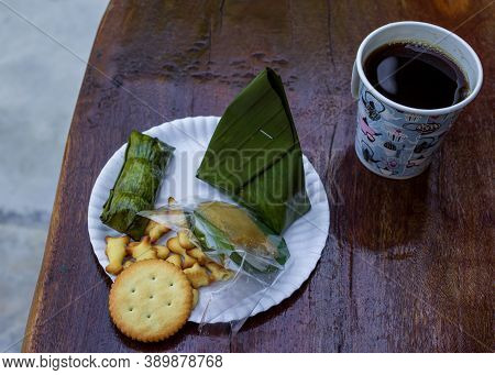Thailand Trip Breakfast Snacks, Coocies And Traditional Sweets On Plastic Plate, Black Warm Cofee