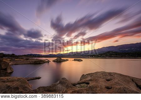Long Exposure Wide Angle Image Of Dawn Breaking Over The Lac De Codole And Distant Mountains In The 