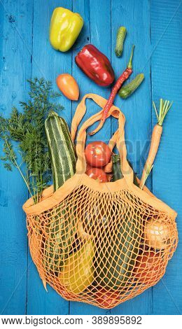 The Concept Of Zero Waste. Eco-friendly Cotton Bag With Vegetables On A Background Of Blue Boards